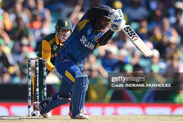 South African wicketkeeper Quinton de Kock looks on as Sri Lankan cricketer Kumar Sangakkara plays a shot during the 2015 Cricket World Cup...
