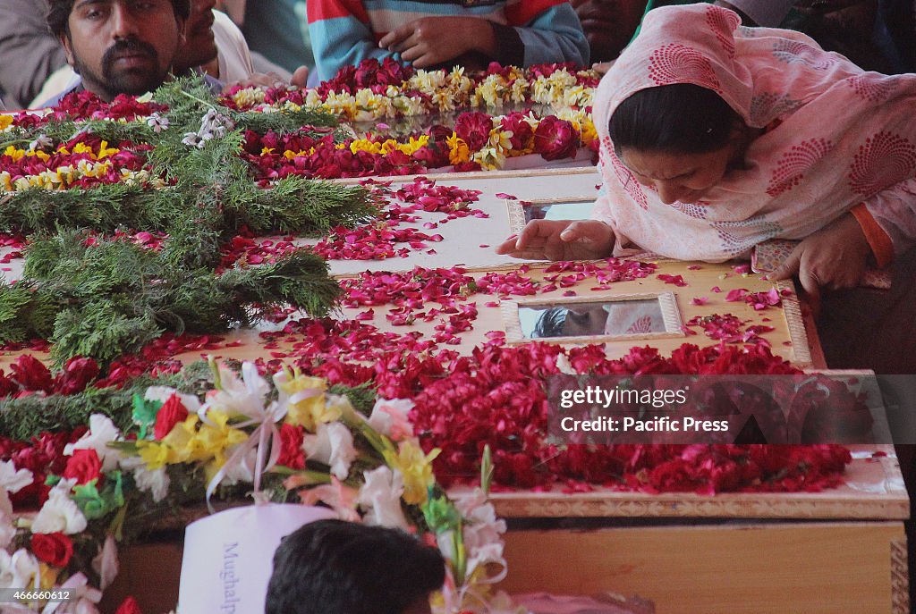 Pakistani Christian community carry the coffin of a victim...
