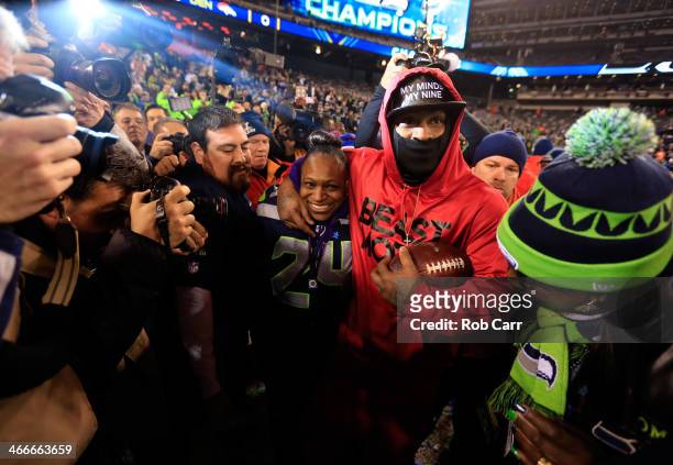 Running back Marshawn Lynch of the Seattle Seahawks celebrates with his mother Delisa Lynch after their 43-8 victory over the Denver Broncos during...