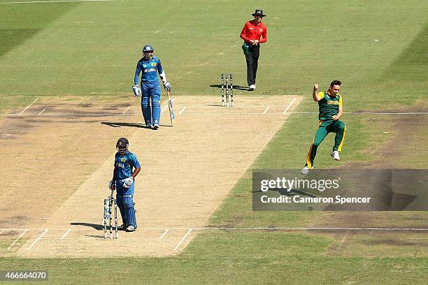 Kyle Abbott of South Africa celebrates dismissing Kusal Perera of Sri Lanka during the 2015 ICC Cricket World Cup match between South Africa and Sri...