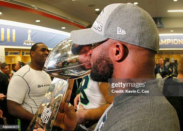 Fullback Michael Robinson of the Seattle Seahawks celebrates with the Vince Lombardi Trophy after in the locker room after the 43-8 victory over the...