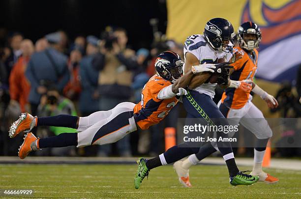 Denver Broncos cornerback Champ Bailey gets a hold of Seattle Seahawks wide receiver Doug Baldwin during the fourth quarter. The Denver Broncos vs...