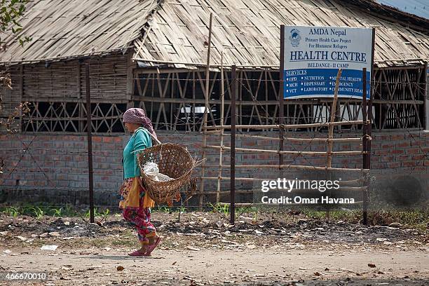 Refugees walks in front of the Primary Health Care centre run by the Association of Medical Doctors of Asia and funded by the UN High Commissioner...