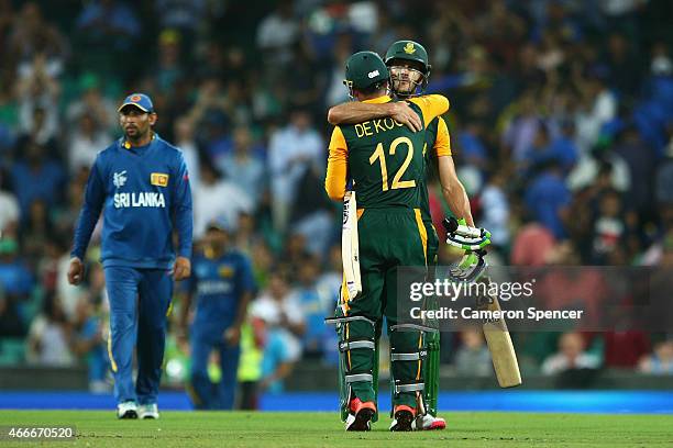 Faf du Plessis of South Africa and team mate Quinton de Kock embrace after winning the 2015 ICC Cricket World Cup match between South Africa and Sri...