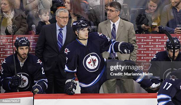 Winnipeg Jets' assistant coach Perry Pearn and head coach Claude Noel stand at the bench behind players Chris Thorburn, Michael Frolik and Eric...