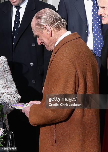 Prince Phillip, Duke of Edinburgh and Queen Elizabeth II are presented with gifts as they attend church at West Newton on February 2, 2014 in King's...