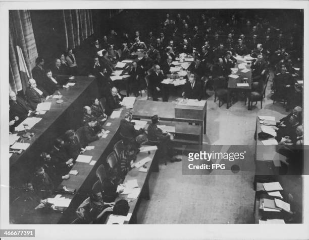 Scene from the courtroom of the Nuremberg War Crimes Trials following World War Two, with the lawyers next to the flags from their own countries;...