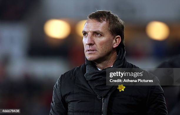 Liverpool manager Brendan Rodgers looks at the score board in the last minutes of the Premier League match between Swansea City and Liverpool at the...