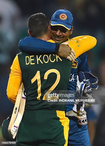 Sri Lankan cricketer Kumar Sangakkara hugs South Africa's Quinton de Kock after the 2015 Cricket World Cup quarter-final match between Sri Lanka and...