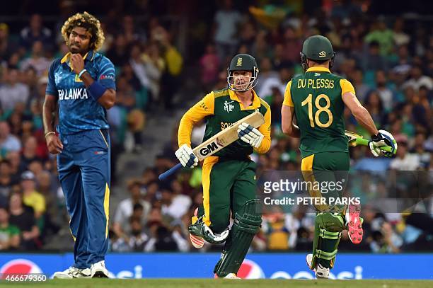 Sri Lanka's bowler Lasith Malinga looks on as South Africa's Quinton de Kock and Faf du Plessis score runs during the 2015 Cricket World Cup...