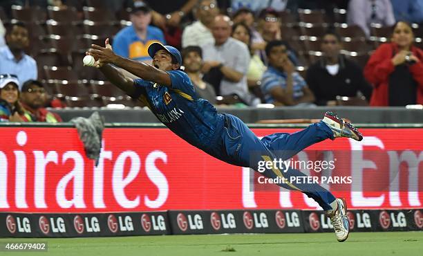 Sri Lanka's Tharindu Kaushal dives in a failed catch attempt during the 2015 Cricket World Cup quarter-final match between South Africa and Sri Lanka...