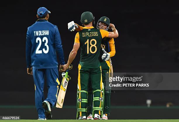 South Africa's Quinton de Kock embraces teammate Faf du Plessis after victory as Sri Lanka's Tillakaratne Dilshan looks on, in the 2015 Cricket World...