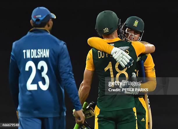 South Africa's Quinton de Kock embraces teammate Faf du Plessis after victory as Sri Lanka's Tillakaratne Dilshan looks on, in the 2015 Cricket World...