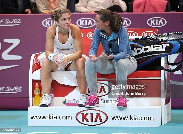 Sara Errani of Italy receives some advice of her doubles partner Roberta Vinci between sets during the final of the 22nd Open GDF Suez held at the...