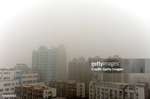 Buildings are shrouded in smog on February 2, 2014 in Shanghai, China. China's national meteorological authority issues an alert as heavy fog will...