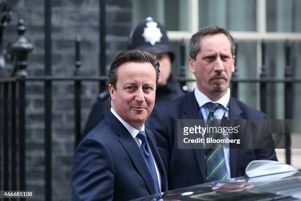David Cameron, U.K. Prime minister, left, leaves 10 Downing Street following a pre-budget cabinet meeting in London, U.K., on Wednesday, March 18,...