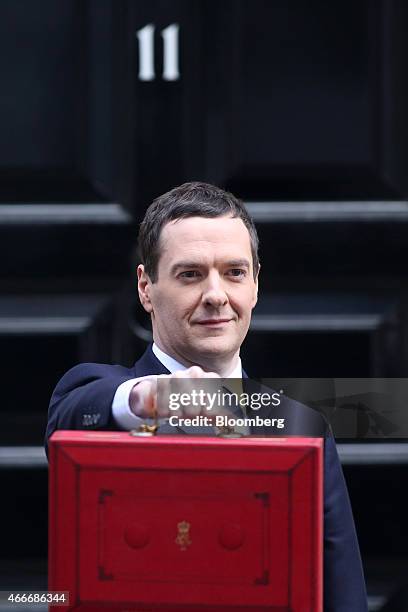 George Osborne, U.K. Chancellor of the exchequer, holds the dispatch box containing the 2015 budget as he stands outside 11 Downing Street in London,...