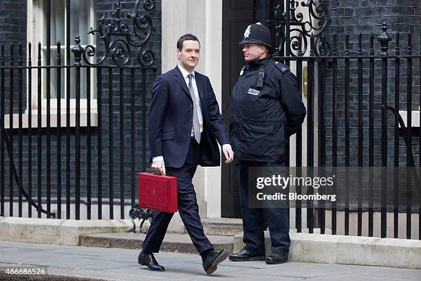 George Osborne, U.K. Chancellor of the exchequer, holds the dispatch box containing the 2015 budget as he stands outside 11 Downing Street in London,...