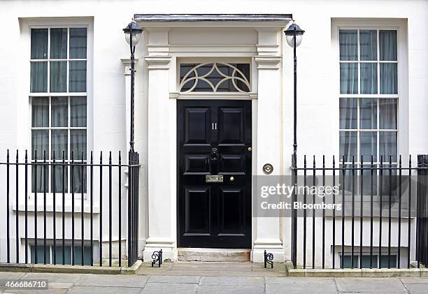 Lamp posts stand either side of 11 Downing Street, the official residence of George Osborne, U.K. Chancellor of the exchequer, in London, U.K., on...