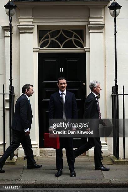 The Chancellor of the Exchequer George Osborne prepares to hold his ministerial red box up to the media as he leaves 11 Downing Street on March 18,...
