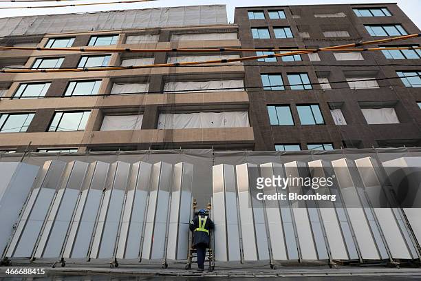 Worker looks inside the Parkhouse Grand Minamiaoyama Takagicho residential building, developed by Mitsubishi Jisho Residence Co., a unit of...