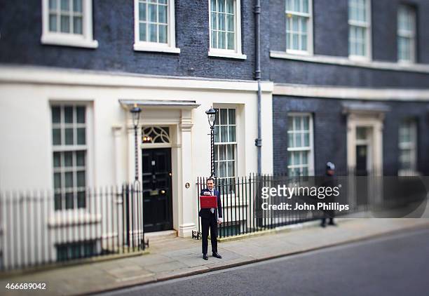 Chancellor of the Exchequer George Osborne holds his ministerial red box up to the media as he leaves number 11 Downing Street for Parliament on...