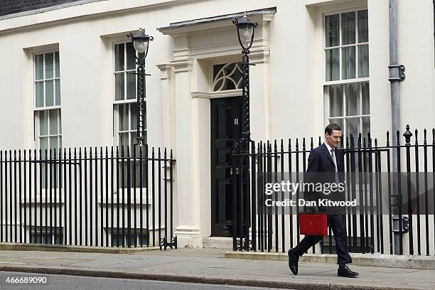 The Chancellor of the Exchequer George Osborne holds his ministerial red box as he leaves 11 Downing Street on March 18, 2015 in London, England. The...