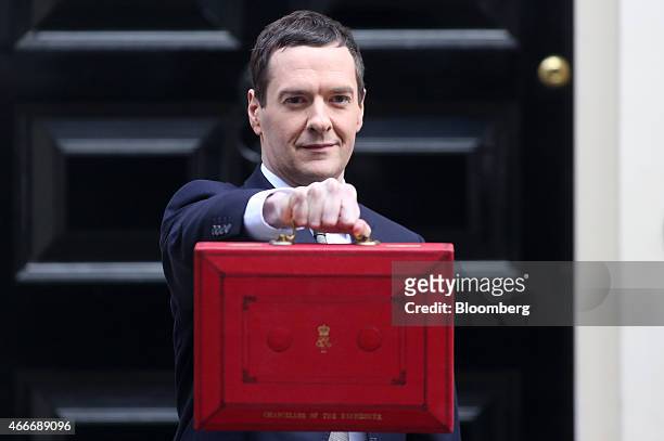 George Osborne, U.K. Chancellor of the exchequer, holds the dispatch box containing the 2015 budget as he stands outside 11 Downing Street in London,...