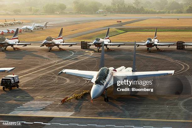 Sukhoi SU-30 MKM fighter jet, developed by Sukoi for the Royal Malaysian Air Force , front, sits on the tarmac at the Langkawi International Maritime...