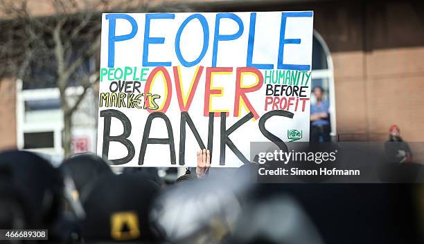 Activists hold up a banner during a demonstration organized by the Blockupy movement to protest against the policies of the European Central Bank...