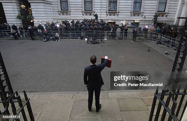Chancellor of the Exchequer George Osborne holds his ministerial red box up to photographers as he stands outside number11 Downing Street on March...