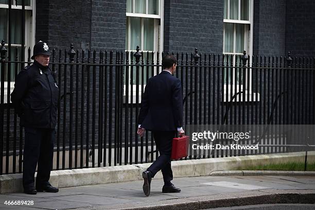 The Chancellor of the Exchequer George Osborne holds his ministerial red box as he leaves 11 Downing Street on March 18, 2015 in London, England. The...