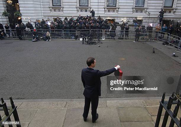 Chancellor of the Exchequer George Osborne holds his ministerial red box up to photographers as he stands outside number11 Downing Street on March...