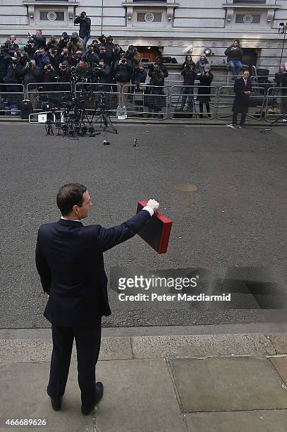 Chancellor of the Exchequer George Osborne holds his ministerial red box up to photographers as he stands outside number11 Downing Street on March...