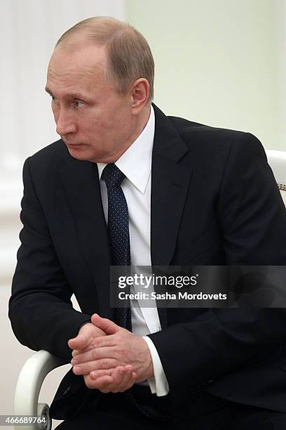 Russian President Vladimir Putin attends a meeting with President of South Ossetia Leonid Tibilov on March 18, 2015 in Moscow, Russia. A Lower House...