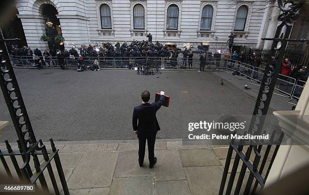 Chancellor of the Exchequer George Osborne holds his ministerial red box up to photographers as he stands outside number11 Downing Street on March...