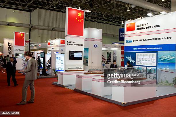 Attendees browse Chinese State Administration for Science, Technology and Industry for National Defense booths during the Langkawi International...