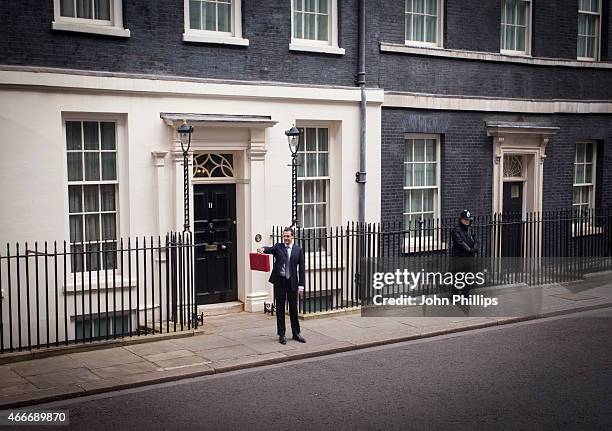 Chancellor of the Exchequer George Osborne holds his ministerial red box up to the media as he leaves number 11 Downing Street for Parliament on...