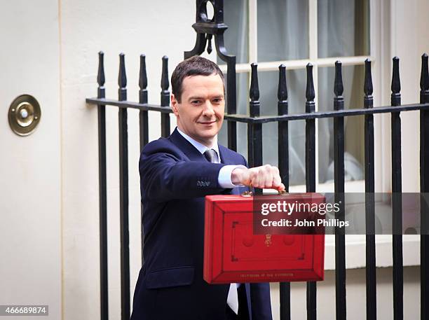 Chancellor of the Exchequer George Osborne holds his ministerial red box up to the media as he leaves number 11 Downing Street for Parliament on...