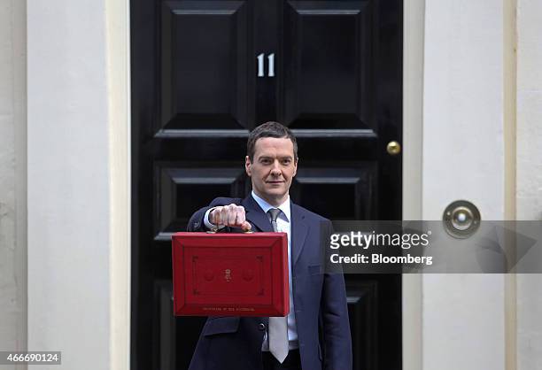 George Osborne, U.K. Chancellor of the exchequer, holds the dispatch box containing the 2015 budget as he stands outside 11 Downing Street in London,...