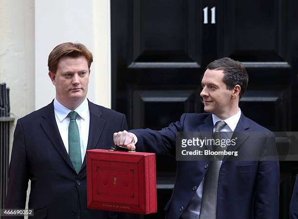 Danny Alexander, U.K. Chief secretary to the treasury, left, watches as George Osborne, U.K. Chancellor of the exchequer, holds the dispatch box...