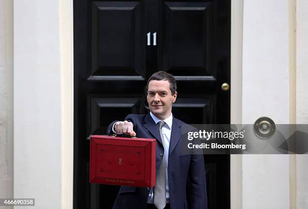 George Osborne, U.K. Chancellor of the exchequer, holds the dispatch box containing the 2015 budget as he stands outside 11 Downing Street in London,...