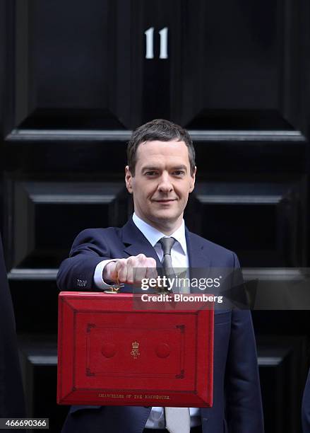 George Osborne, U.K. Chancellor of the exchequer, holds the dispatch box containing the 2015 budget as he stands outside 11 Downing Street in London,...