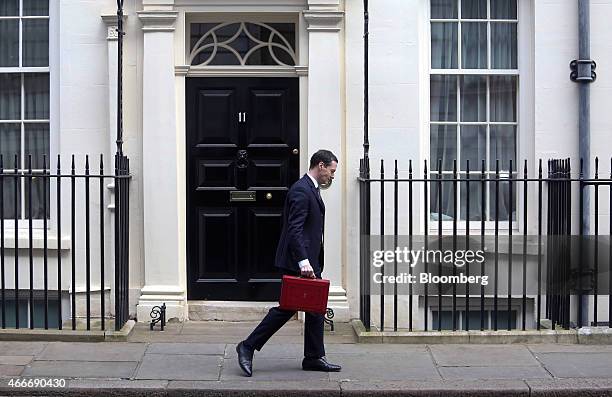 George Osborne, U.K. Chancellor of the exchequer, holds the dispatch box containing the 2015 budget as he leaves 11 Downing Street in London, U.K.,...