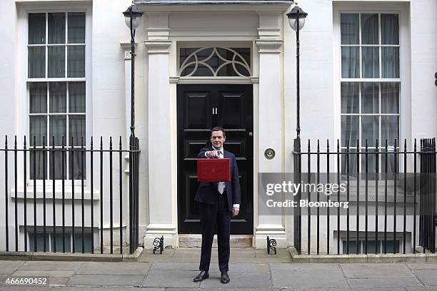 George Osborne, U.K. Chancellor of the exchequer, holds the dispatch box containing the 2015 budget as he stands outside 11 Downing Street in London,...