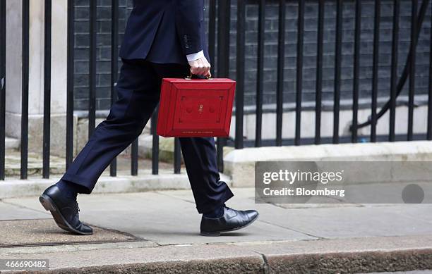 George Osborne, U.K. Chancellor of the exchequer, carries the dispatch box containing the 2015 budget as he leaves Downing Street in London, U.K., on...