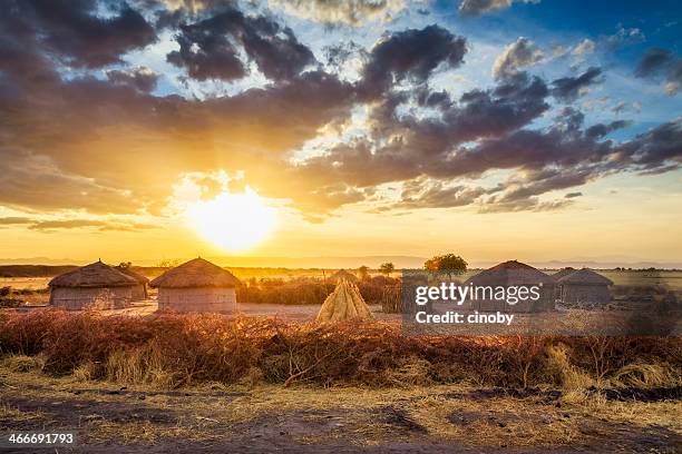 maasai village by sunset - tarangire national park - village of fatisah stockfoto's en -beelden