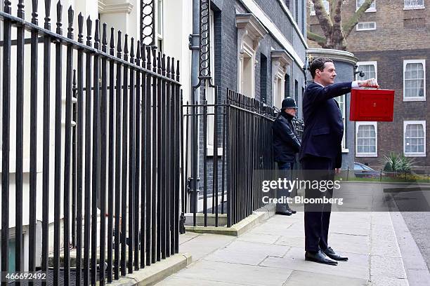 George Osborne, U.K. Chancellor of the exchequer, holds the dispatch box containing the 2015 budget as he stands outside 11 Downing Street in London,...