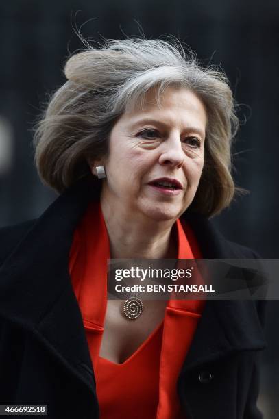 British Home Secretary Theresa May leaves 10 Downing Street in London, on March 18 as Finance Minister George Osborne prepares to unveil the...