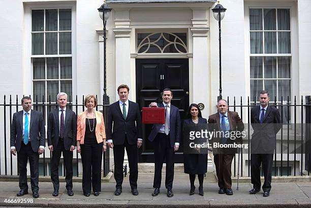 George Osborne, U.K. Chancellor of the exchequer, centre, stands with the H.M. Treasury team, left to right, Gareth Johnson, parliamentary private...